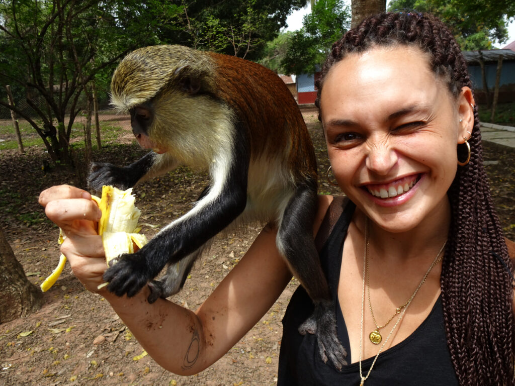 Selfie with Mona Monkey eating banana at the Tafi Atome Sanctuary